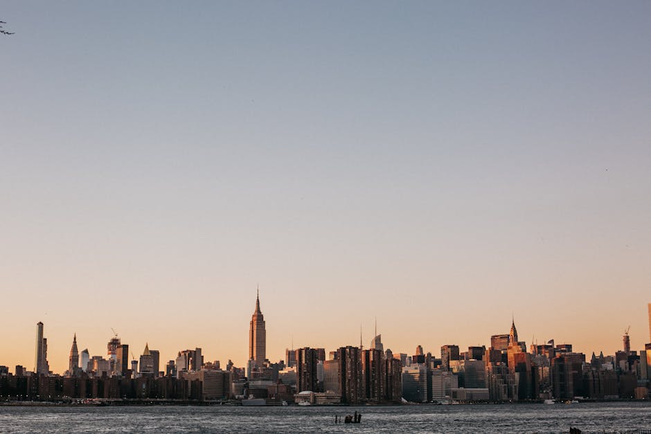 Stunning view of New York City skyline at sunset, featuring the iconic Empire State Building