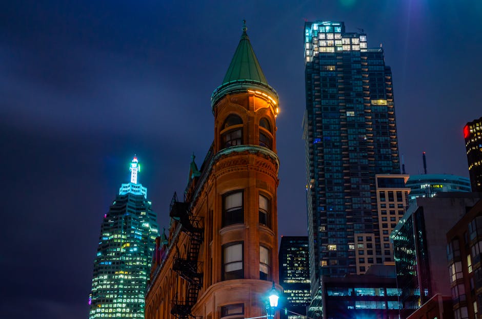Stunning view of Toronto's iconic Gooderham Building illuminated around city skyscrapers at night