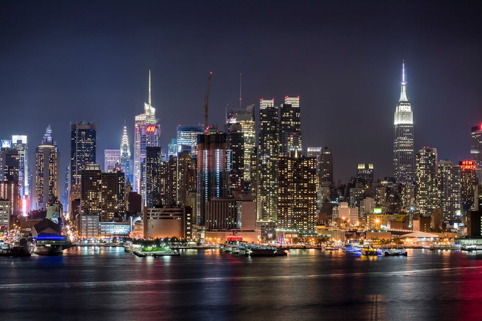 Stunning view of the illuminated New York City skyline reflecting on the Hudson River at night